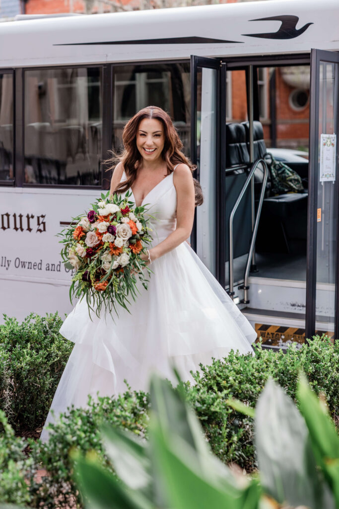 Bride exits white trolley at Savannah wedding